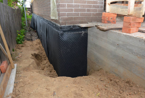 SJ Waterproofing Pros technician performing targeted Interior Drainage System assessment in Arkdale, WI